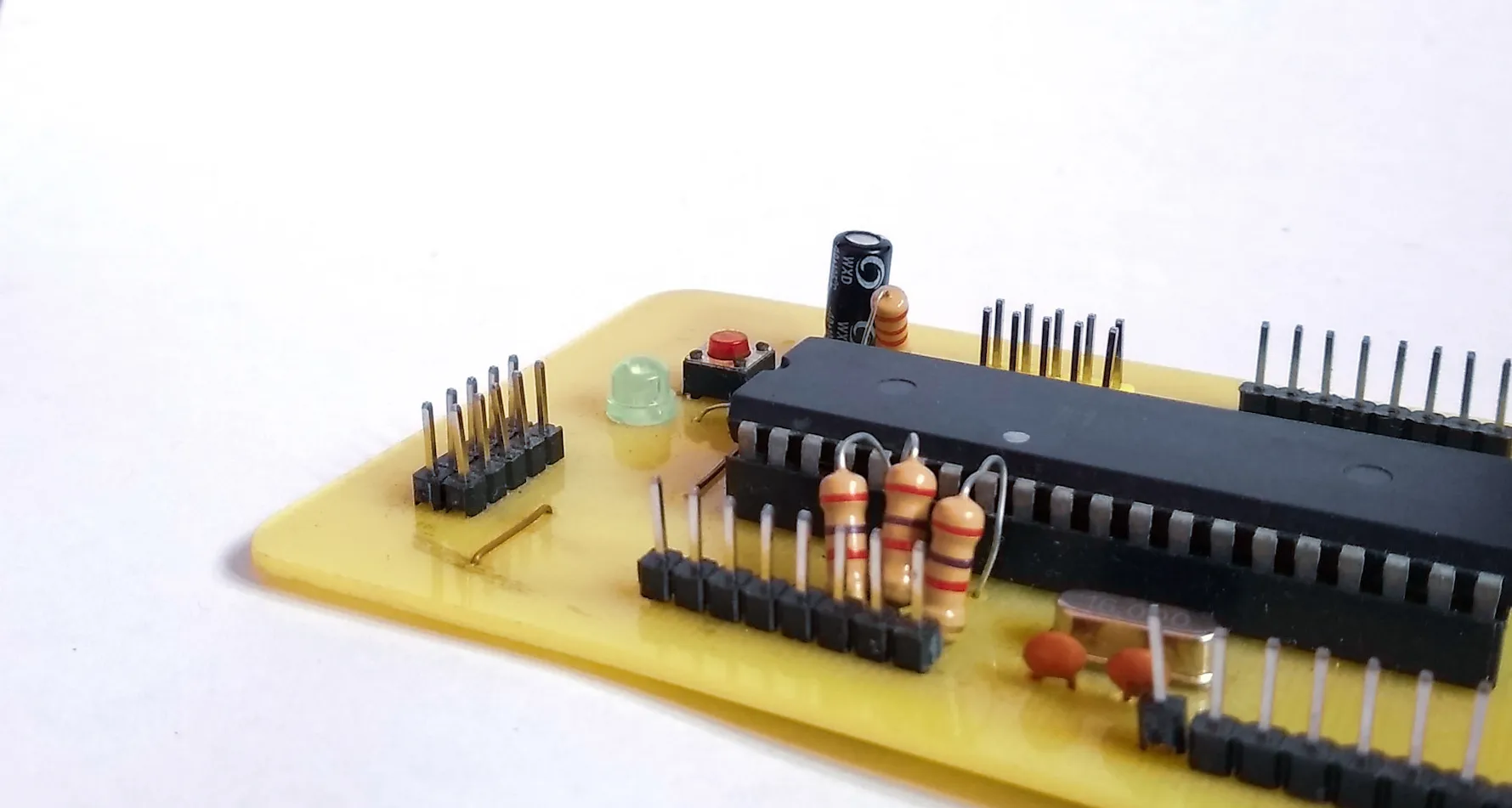 Close-up of the hand-etched ATmega32A board and its headers